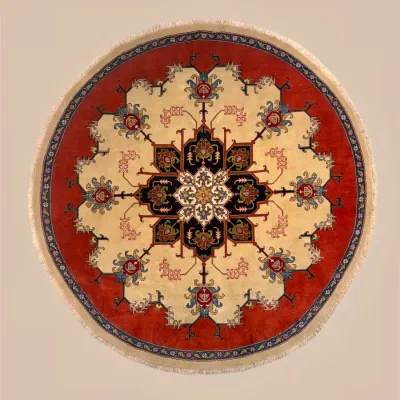 Round traditional rug with bold red border and ornate floral medallion