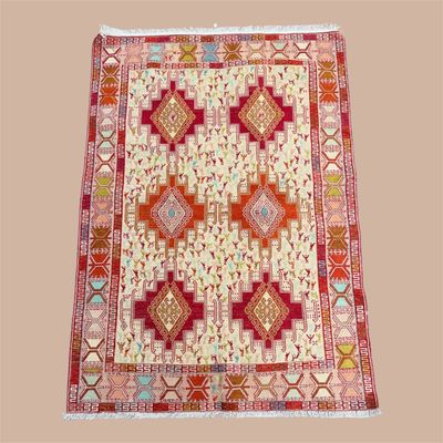 Ivory and rust geometric area rug with repeating diamond medallions