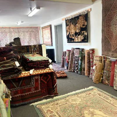 Rug showroom featuring a variety of sizes, colors, and patterns