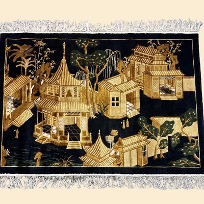 Black and gold decorative pictorial rug featuring an architectural landscape scene