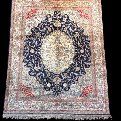 Ivory, navy, and red traditional area rug with elaborate central medallion