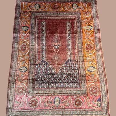 Vintage-inspired traditional rug with warm red, rust, and neutral tones