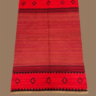 Bold red flatweave rug with black geometric accents
