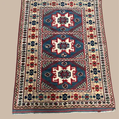 Bold geometric area rug with red, blue, and ivory pattern