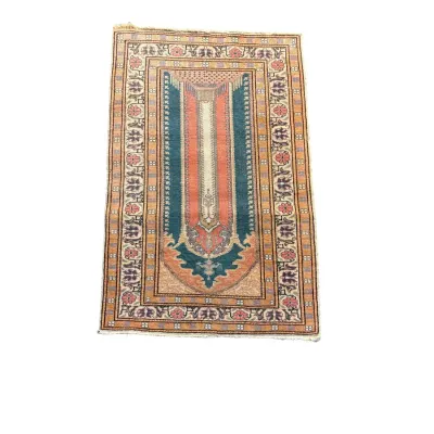 Small traditional rug with colorful striped central design and ornate border