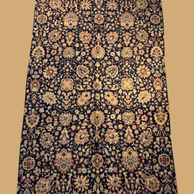 Dark navy traditional area rug with dense repeating floral pattern
