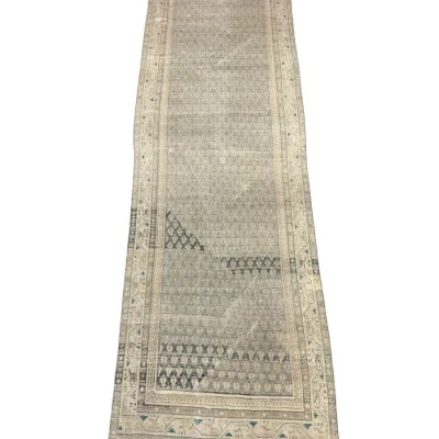 Long neutral runner rug with subtle traditional pattern