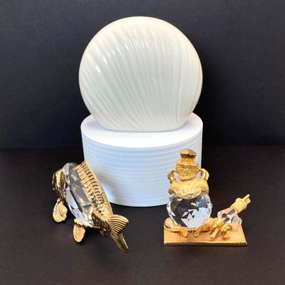 LOT 109: Lenox Desk / Table Clock, Crystal / Gold Tone Fish and Trimlite Strass Clown with Cannon Figurines