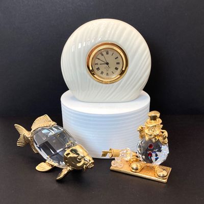 LOT 109: Lenox Desk / Table Clock, Crystal / Gold Tone Fish and Trimlite Strass Clown with Cannon Figurines