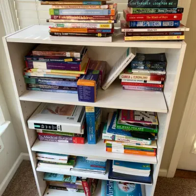 Basic Bookcase With A Wide Variety Of Books, Including Some Educational For Nursing