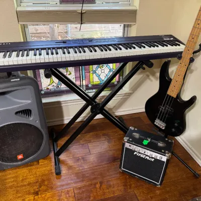 JBL Eon Power speaker, Kurzweil keyboard SP88, Ibanez 4 string electric guitar TRB50, FirstAct Amplifier