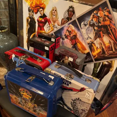 Collection of 80s lunch boxes, Adventurers, Spider Man, Captain Marvel and Power women poster