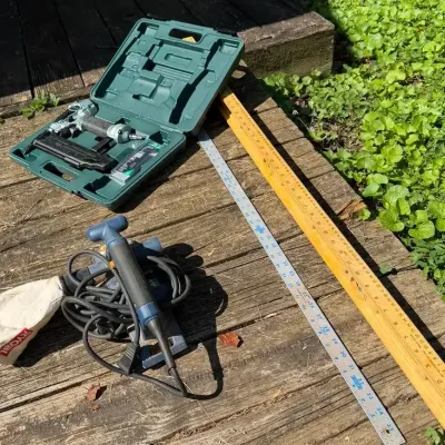 Nail Gun, Sander, And Level