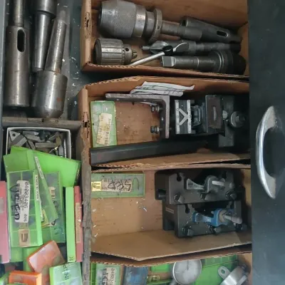 Sale Photo Thumbnail #99: metalworking tools, including lathe holders, drill chucks, and milling head components.