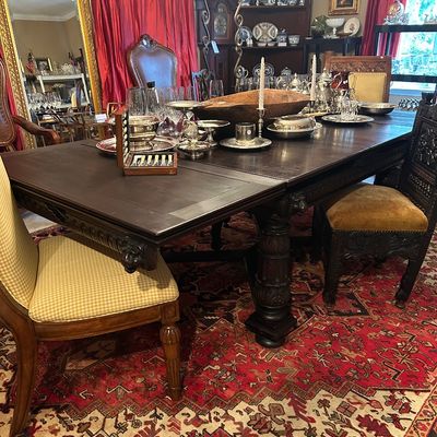 Hand-carved table measures 99" long x 45" wide. Expandable to 145" long with two hidden leaves. $725