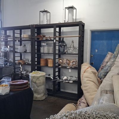 Assorted Modern Lighting Fixtures, Decorative Decor Items, and Rolled Area Rugs