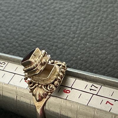 Sale Photo Thumbnail #141: Vintage 925 marked snuff ring with a dark red colored stone 
Please see attached pictures