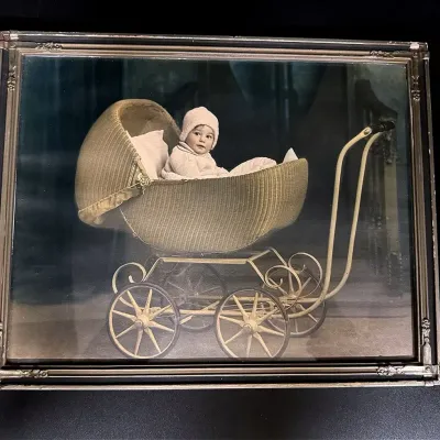Vintage Photograph Of A Child Sitting In A Vintage Wicker Baby Carriage
