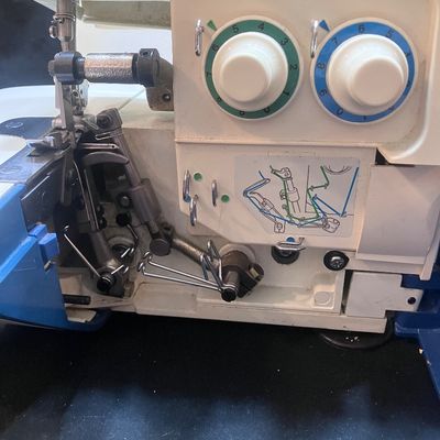 Sale Photo Thumbnail #1146: BROTHER MODEL 523N OVERLOCK SEWING MACHINE/SERGER MADE IN JAPAN. INCLUDES FOOT PEDAL, POWER CORD, SPOOLS OF THREAD, STENCIL TEMPLATE, MANUALS, AND MORE. PRE-OWNED CONDITION WITH LIGHT SURFACE WEAR.