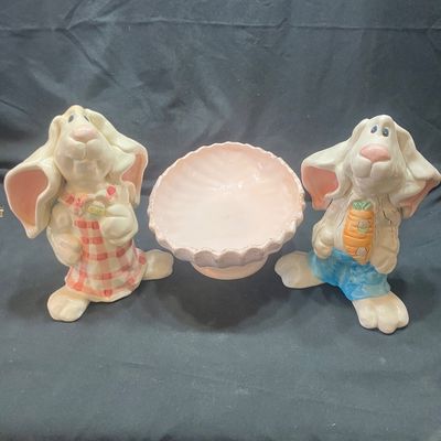 Sale Photo Thumbnail #1315: WCL CERAMIC EASTER BUNNY FIGURINES AND GOLDEN PINE PN-4 FOOTED BOWL. INCLUDES TWO CERAMIC BUNNY FIGURES WITH WCL MARKINGS AND ONE PINK FOOTED BOWL WITH GOLD PINE CONE ACCENTS. LIGHT WEAR, NO VISIBLE CHIPS OR CRACKS.