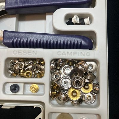 Sale Photo Thumbnail #1266: PRYM VARIO PLUS SNAP FASTENER AND EYELET PLIER KIT. INCLUDES VARIO PLIERS, ASSORTED SNAPS, EYELETS, ATTACHMENTS, INSTRUCTIONS, AND MORE. LIGHTLY USED CONDITION IN ORIGINAL PLASTIC CASE.