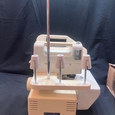 Sale Photo Thumbnail #1149: BROTHER MODEL 523N OVERLOCK SEWING MACHINE/SERGER MADE IN JAPAN. INCLUDES FOOT PEDAL, POWER CORD, SPOOLS OF THREAD, STENCIL TEMPLATE, MANUALS, AND MORE. PRE-OWNED CONDITION WITH LIGHT SURFACE WEAR.