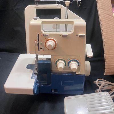 Sale Photo Thumbnail #1143: BROTHER MODEL 523N OVERLOCK SEWING MACHINE/SERGER MADE IN JAPAN. INCLUDES FOOT PEDAL, POWER CORD, SPOOLS OF THREAD, STENCIL TEMPLATE, MANUALS, AND MORE. PRE-OWNED CONDITION WITH LIGHT SURFACE WEAR.