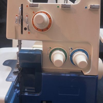 Sale Photo Thumbnail #1147: BROTHER MODEL 523N OVERLOCK SEWING MACHINE/SERGER MADE IN JAPAN. INCLUDES FOOT PEDAL, POWER CORD, SPOOLS OF THREAD, STENCIL TEMPLATE, MANUALS, AND MORE. PRE-OWNED CONDITION WITH LIGHT SURFACE WEAR.