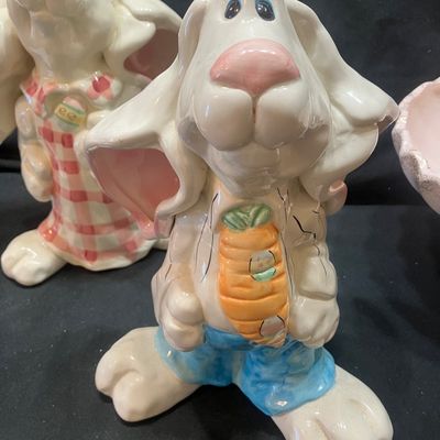 Sale Photo Thumbnail #1308: WCL CERAMIC EASTER BUNNY FIGURINES AND GOLDEN PINE PN-4 FOOTED BOWL. INCLUDES TWO CERAMIC BUNNY FIGURES WITH WCL MARKINGS AND ONE PINK FOOTED BOWL WITH GOLD PINE CONE ACCENTS. LIGHT WEAR, NO VISIBLE CHIPS OR CRACKS.