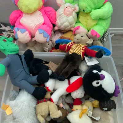 Two Bins Full Of A Mixture Of Stuffed Animals 
