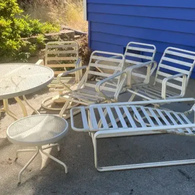 Two Glass Top Patio Tables with Metal Patio Chairs including Rockers and Lounger 