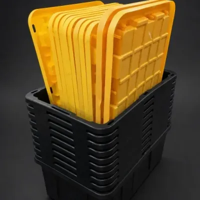 Stacked Black Plastic Storage Totes With Yellow Lids