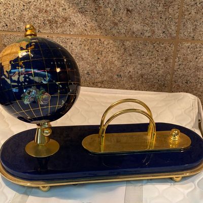 Gem Globe semi-precious gemstone desk organizer featuring a rotating globe made from lapis lazuli.
It includes a brass stand for the...
