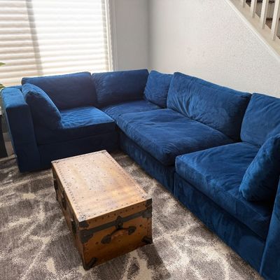 Sale Photo Thumbnail #66: Navy blue sectional and antique trunk