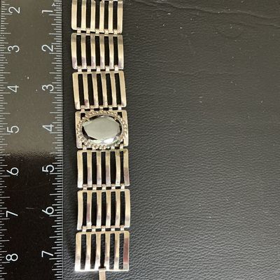 Sale Photo Thumbnail #166: Silver Tone ladder link statement bracelet with mirrored hematite style stone has wearing blemishes 
Please see attached pictures