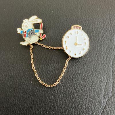Sale Photo Thumbnail #61: Alice and wonder land clock and rabbit pins 
Please see attached pictures
