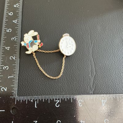 Sale Photo Thumbnail #64: Alice and wonder land clock and rabbit pins 
Please see attached pictures