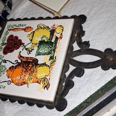Sale Photo Thumbnail #909: Vintage Cast Iron and Ceramic Tile Trivet with Teapot and Kettle Graphic