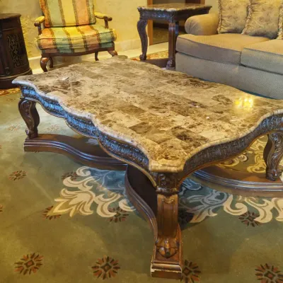 Sale Photo Thumbnail #159: Impressive oversized coffee table featuring a shaped natural-stone-style top composed of richly varied tiles over an extensively carved wood base. Scalloped edges, carved apron, substantial legs, and dramatic stretcher base create a true statement piece. 