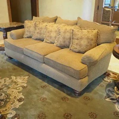 Sale Photo Thumbnail #142: Generously sized three-seat traditional sofa featuring neutral textured upholstery, oversized rolled arms, loose seat and back cushions, and coordinating paisley accent pillows. Substantial comfortable seating suitable for a family room, living room, or l