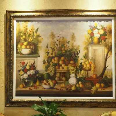 Sale Photo Thumbnail #64: Impressive oversized traditional still life featuring abundant fruit and floral arrangements in an ornate antiqued frame with decorative inner molding. Rich Old World palette and substantial scale make this a strong statement piece. Over 70" w and over 60