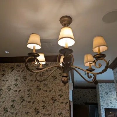 Sale Photo Thumbnail #85: Substantial traditional chandelier featuring scrolling metal arms, dimensional leaf detailing, and coordinating fabric shades. Antiqued bronze/gold finish with elegant Old World design. Buyer responsible for removal. Approx 38" round