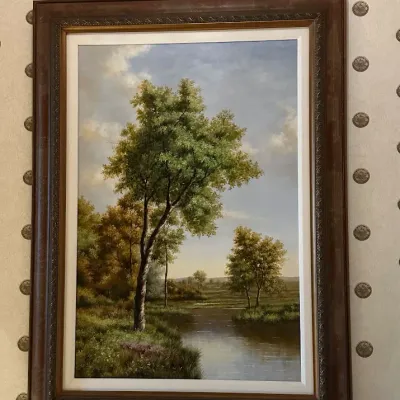 Sale Photo Thumbnail #73: Traditional landscape featuring mature trees beside calm water under an open sky. Nicely presented in a substantial dark wood-tone frame with decorative inner molding.