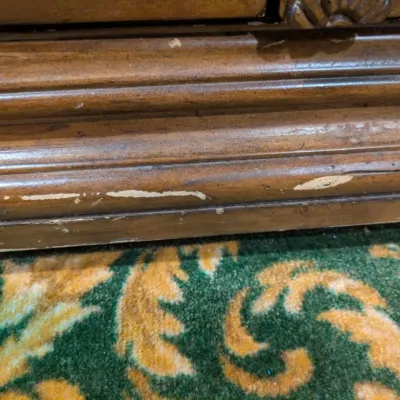 Sale Photo Thumbnail #40: Large traditional-style wood cabinet featuring deeply carved doors, decorative trim, upper drawers, and substantial molding throughout. Rich warm finish with an impressive architectural look. Ideal as a bar cabinet, storage cabinet, entry piece, or statem
