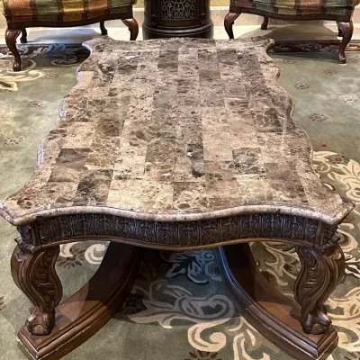 Sale Photo Thumbnail #161: Impressive oversized coffee table featuring a shaped natural-stone-style top composed of richly varied tiles over an extensively carved wood base. Scalloped edges, carved apron, substantial legs, and dramatic stretcher base create a true statement piece. 