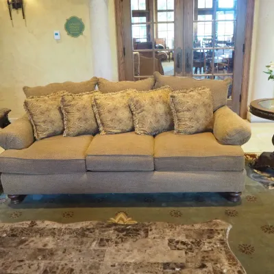 Sale Photo Thumbnail #141: Generously sized three-seat traditional sofa featuring neutral textured upholstery, oversized rolled arms, loose seat and back cushions, and coordinating paisley accent pillows. Substantial comfortable seating suitable for a family room, living room, or l