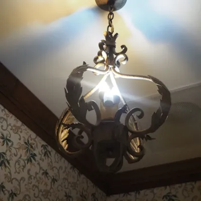 Sale Photo Thumbnail #11: Traditional hanging chandelier featuring ornate iron scrollwork and leaf-inspired detailing in an antiqued finish. A distinctive Old World fixture suitable for a hallway, foyer, or intimate dining area. Buyer responsible for removal.