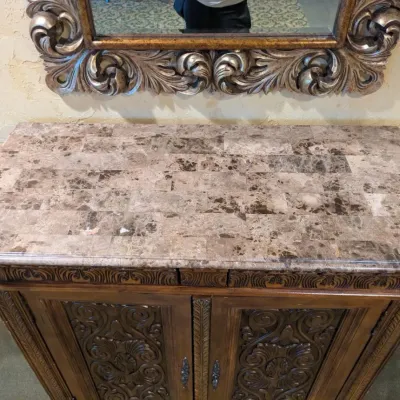 Sale Photo Thumbnail #34: Large traditional-style wood cabinet featuring deeply carved doors, decorative trim, upper drawers, and substantial molding throughout. Rich warm finish with an impressive architectural look. Ideal as a bar cabinet, storage cabinet, entry piece, or statem