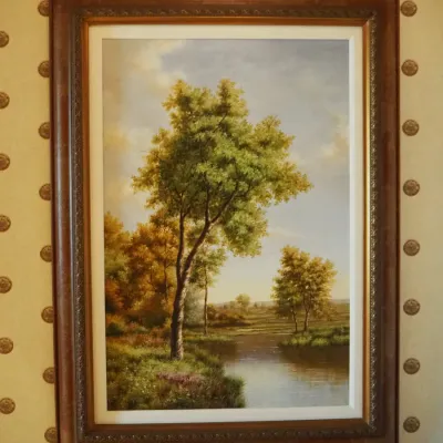 Sale Photo Thumbnail #72: Traditional landscape featuring mature trees beside calm water under an open sky. Nicely presented in a substantial dark wood-tone frame with decorative inner molding.