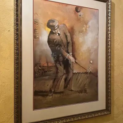 Sale Photo Thumbnail #75: You are bidding on a set of 4 items. Large framed golf artwork depicting a traditionally dressed early-era golfer with clubs and period-inspired graphic elements. Warm sepia and golden tones, professionally matted, and presented in an ornate antiqued fram